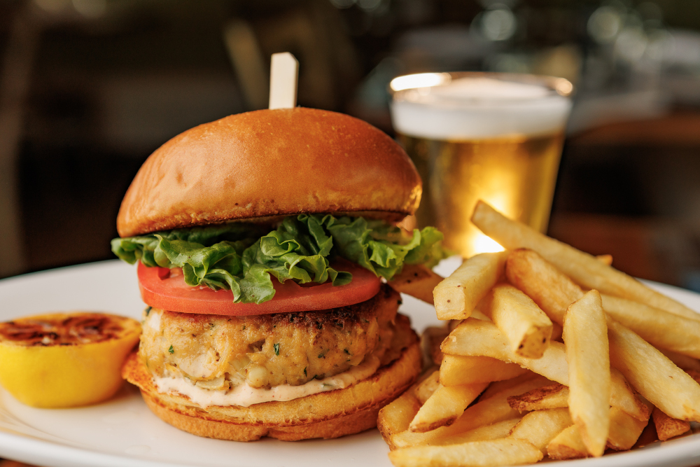 crab cake sandwich on a plate with french fries